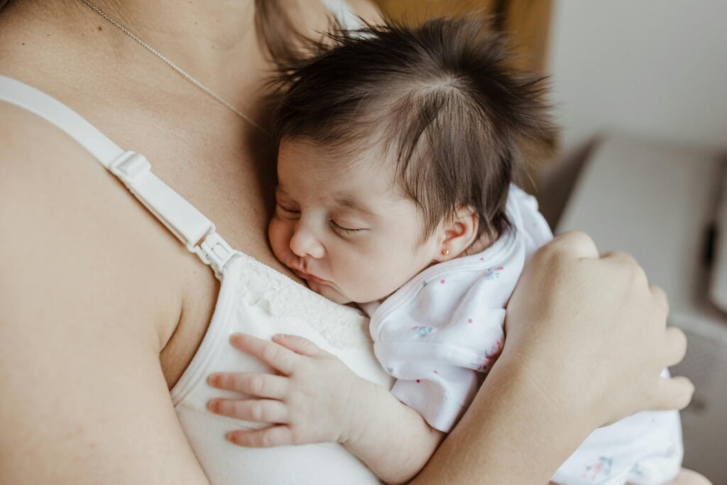 A tender moment with a newborn sleeping peacefully on their mother's chest, showcasing the bond of love.
